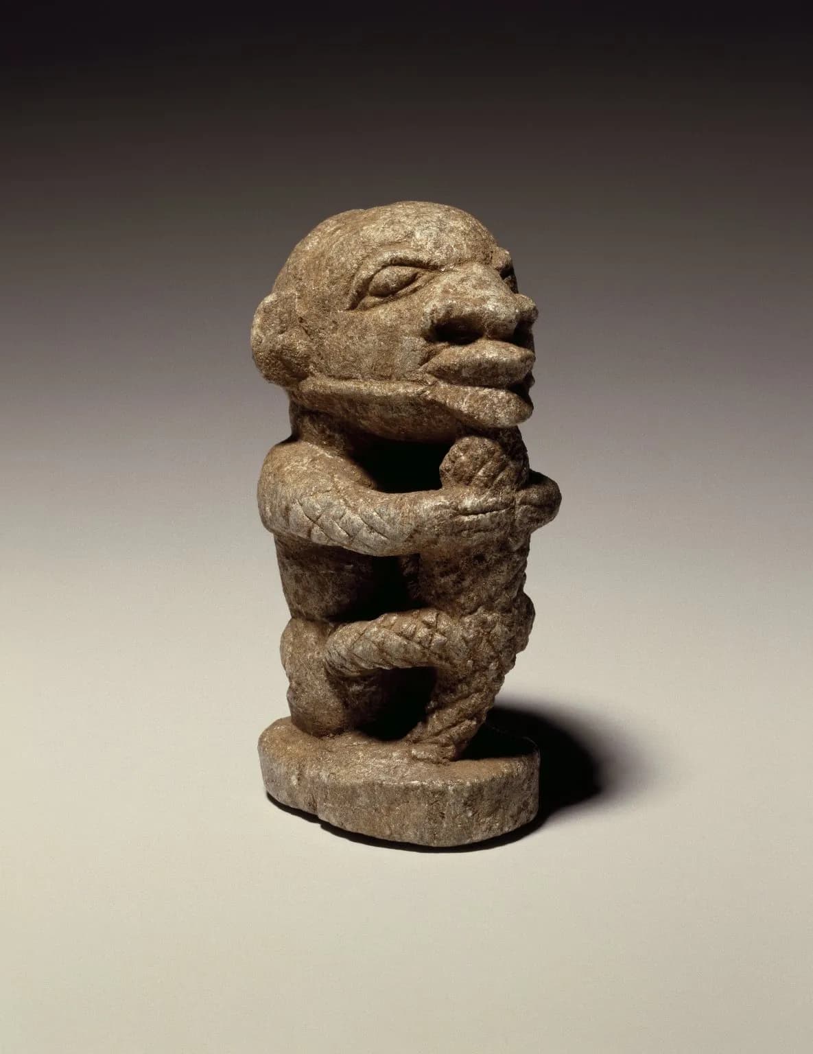 Figure of a Man Holding a Crocodile